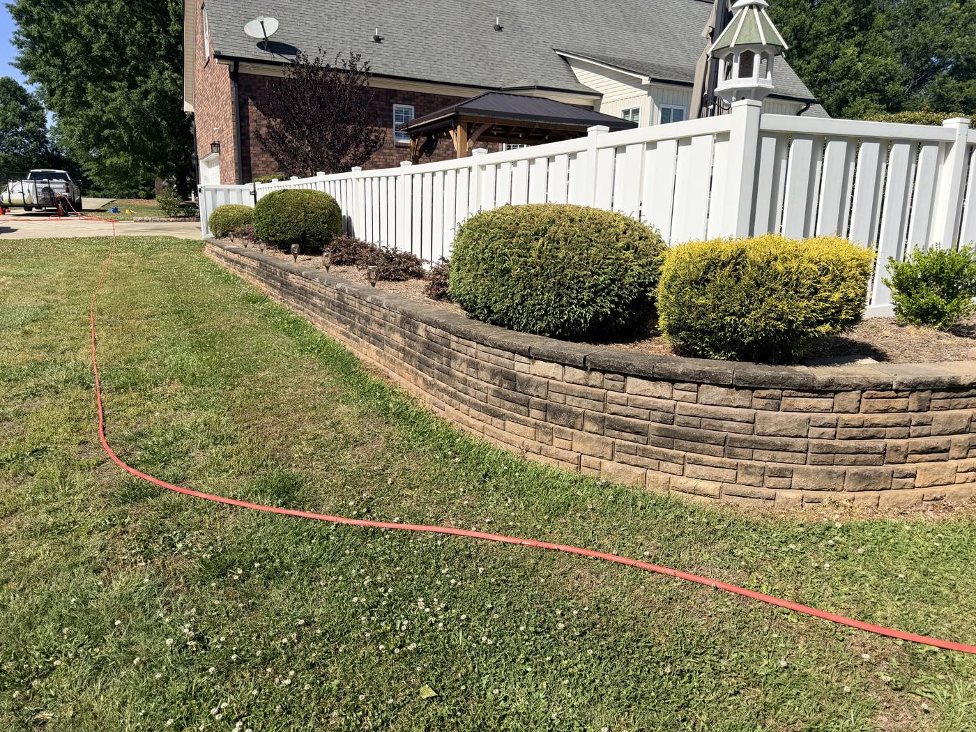 Dirty stained retaining wall before soft washing