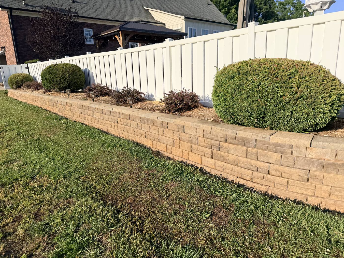 Clean retaining wall after soft washing