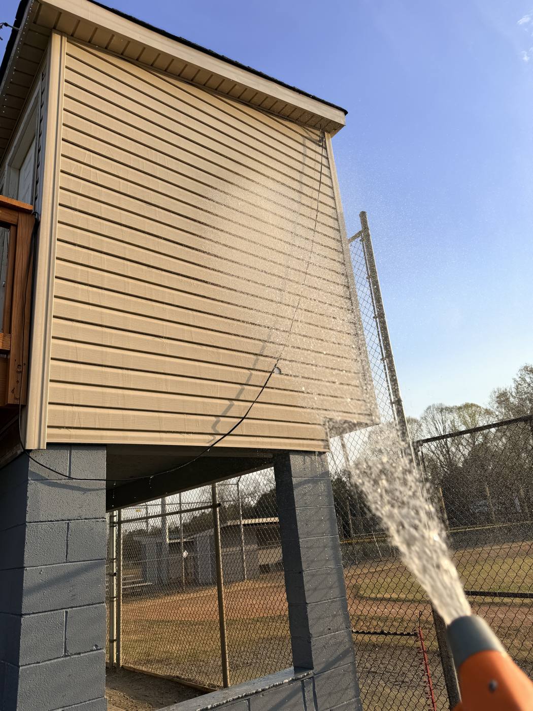 Rinsing exterior siding during a soft wash